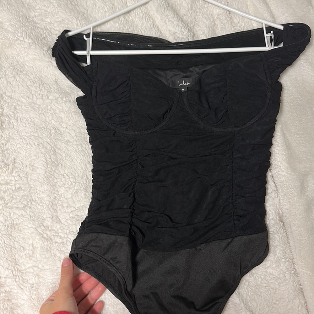 Black bodysuit from the brand Lulus. Size medium and fits comfortably w/ stretch